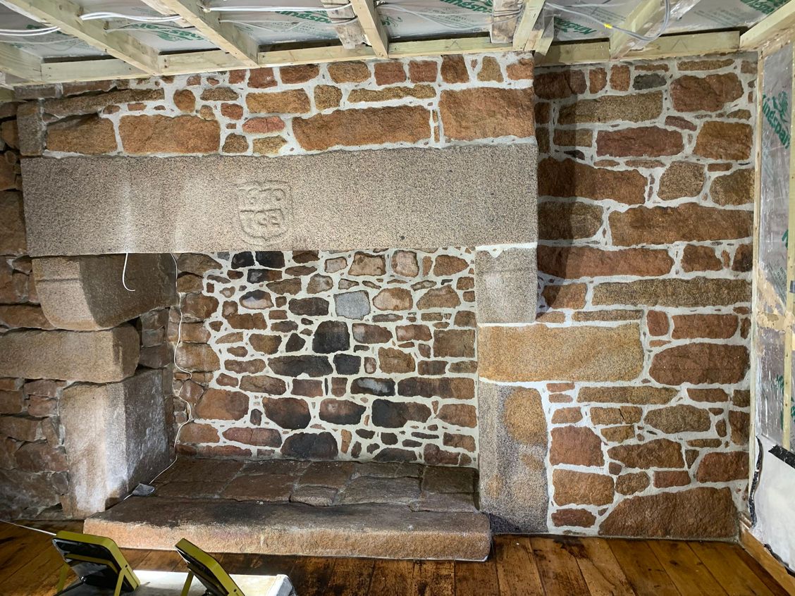 Restored fireplace with coat of arms lintel