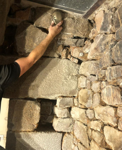 Inspecting the old stonework by hand