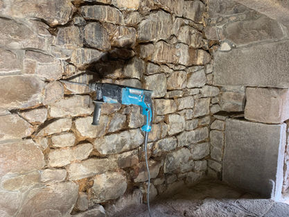 Raking out old mortar inside the fireplace